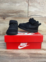 Black Nike toddler sneakers with velcro straps on red shoebox