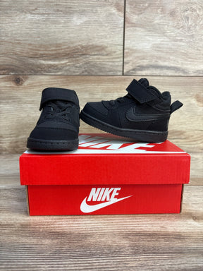 Black Nike toddler sneakers with velcro straps on red shoebox