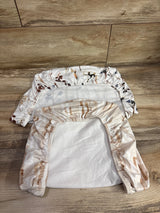 Top view of two white and tan fitted bassinet sheets showcasing elasticized edges and animal print with wood floor background