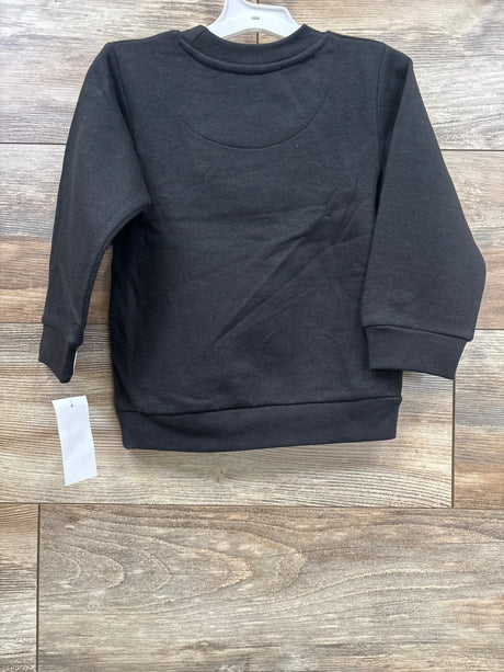 Black long sleeve toddler sweatshirt on wood background, gently used kids clothing