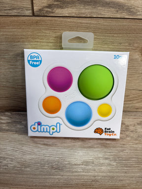 Front of boxed Fat Brain Dimpl showcasing five colorful silicone pop bubbles with wood background