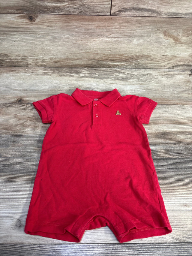 Front view of Baby Gap red henley romper with collar, button placket, sleeves, embroidered chest logo on wood floor