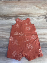 Front flat lay of brown Little Co sandcastle print romper showing sleeveless top and snap crotch on wood background