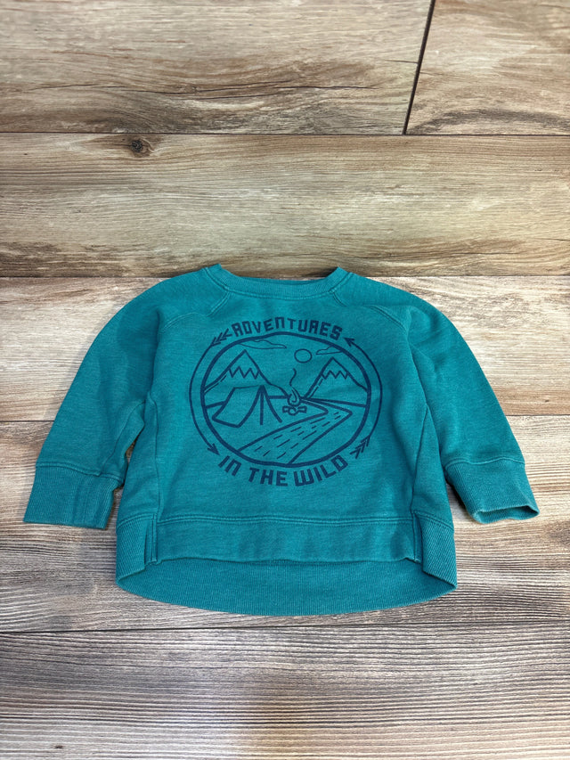 Teal kids pullover with 'Adventures in the Wild' mountain and tent graphic on wood background
