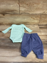 Flat lay of baby 2-piece waffle knit long-sleeve bodysuit and elastic-waist joggers, light aqua top and blue pants on wood background