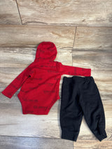 Red baby hooded bodysuit with train print and black pants set on wooden floor