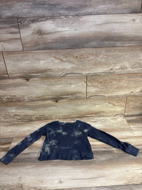 Black and tan tie-dye long sleeve ribbed cropped thermal shirt on wood floor
