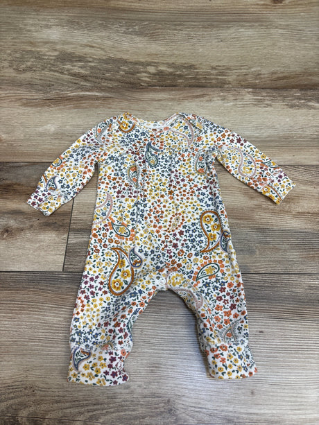 Front view of Carter’s white floral coverall, size 3 months, with long sleeves and paisley pattern on wood flooring