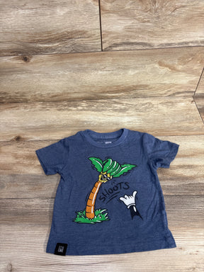Blue toddler t-shirt with cartoon palm tree and 'Shoots' graphic on wooden background