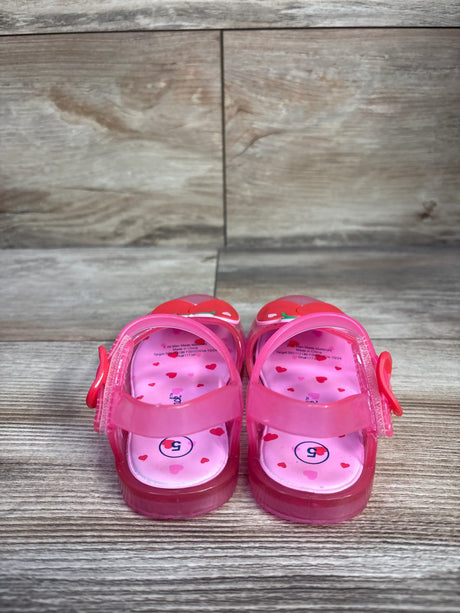 Front view of Cat & Jack pink jelly sandals, size 5C, showing cherry charm on toe strap on white background
