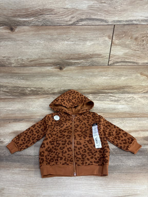 Brown leopard print baby hoodie with zipper and tags on wood background