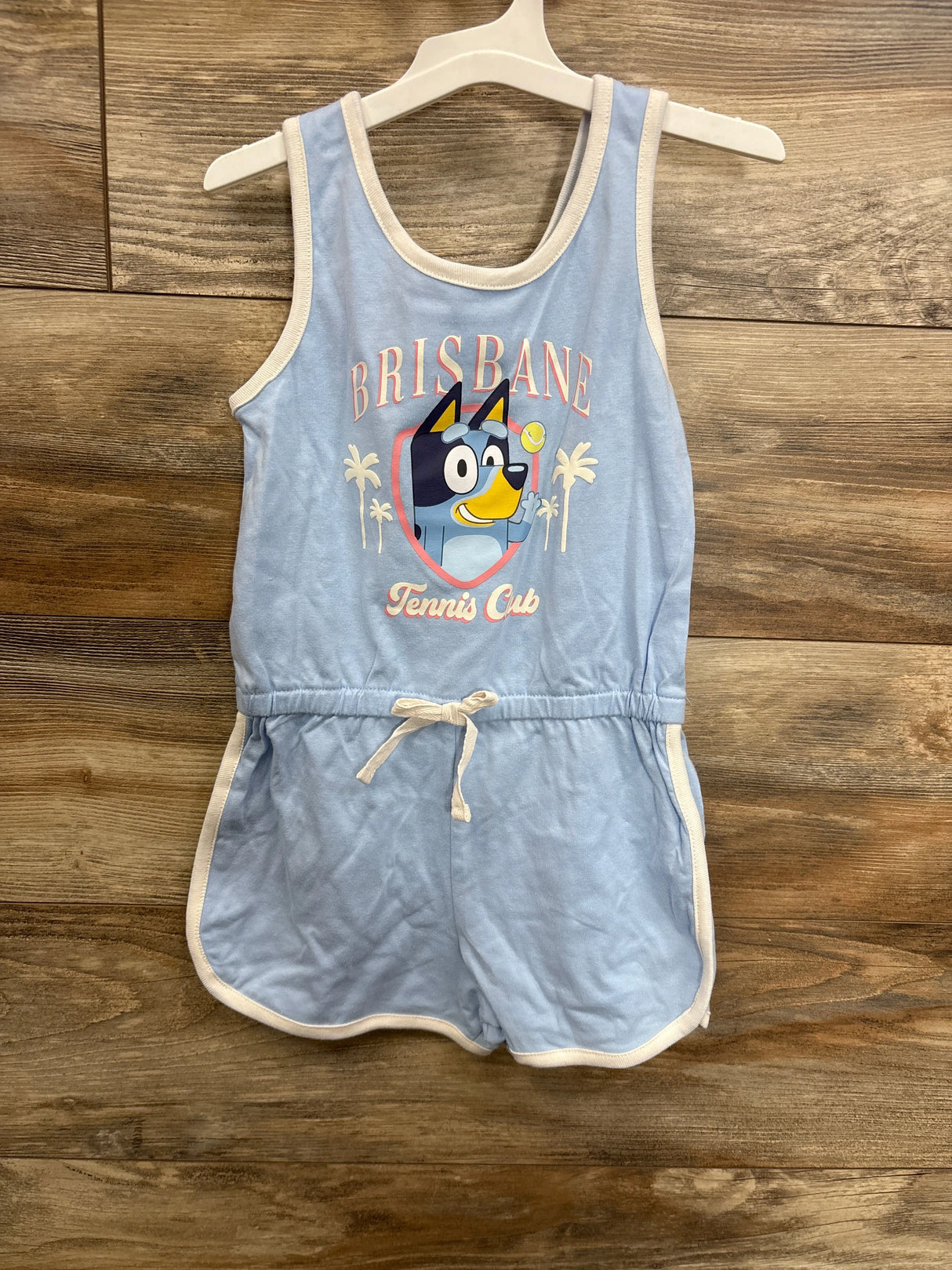Light blue kids romper with cartoon dog, 'Brisbane Tennis Club' print, white trim, drawstring waist