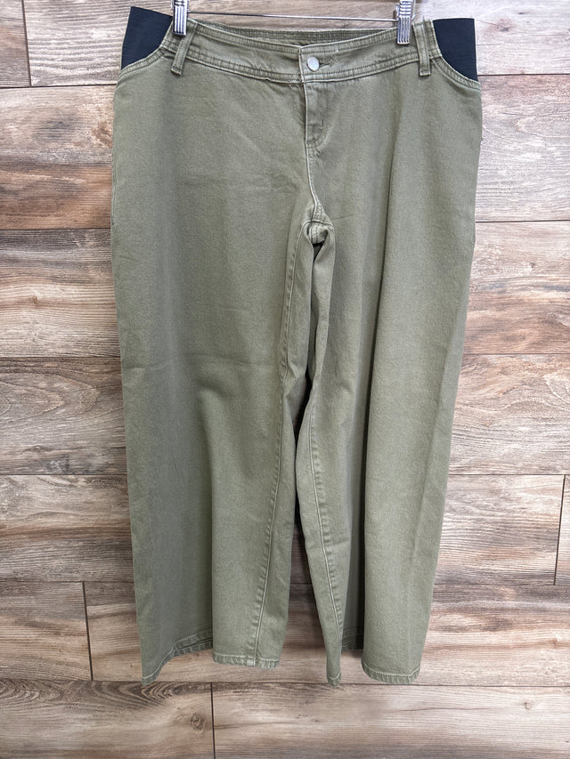 Front view of green Isabel maternity wide-leg jeans showing black side stretch maternity panels hanging on clips against wood background