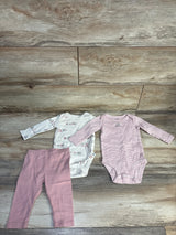 Flat lay of Carter's 3-piece infant set: ivory printed bodysuit, pink striped bodysuit, and pink leggings on wood floor
