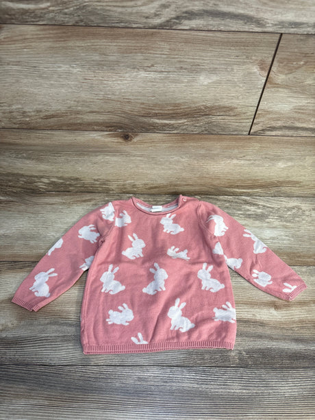 Pink baby sweater with white bunny print, long sleeves, laid on wood floor
