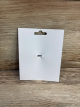 Front view of Dragonfly hair bow showcasing small silver coiled center attachment on white display card with woodgrain background