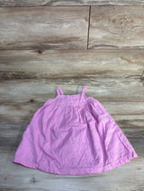 Flat lay of Baby Gap pink embroidered toddler dress size 18-24 months showing floral embroidery on wooden background