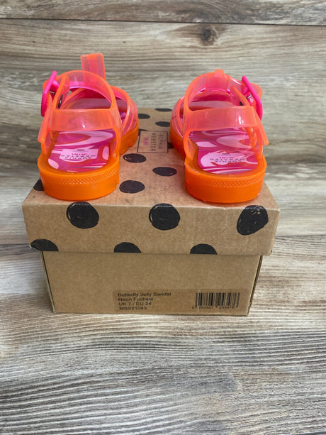 Rear view of Sophia Webster Butterfly Jelly sandals in neon fuchsia with orange soles on polka-dot box, buckle straps, size UK7/EU24