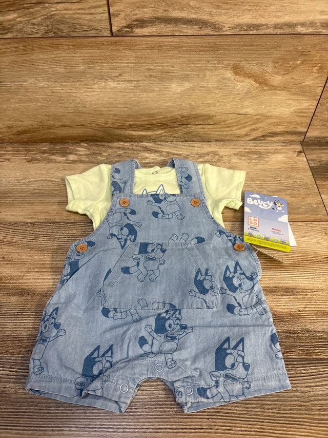 Bluey baby overalls with yellow shirt, denim print, wooden floor