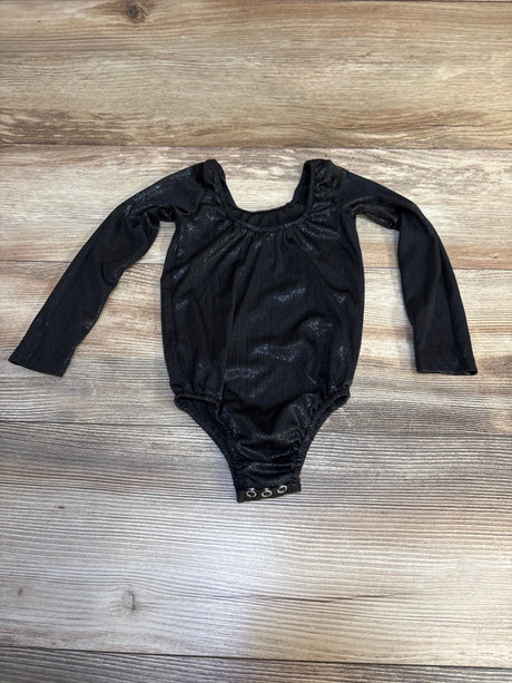 Black long sleeve baby bodysuit with snap bottom on wood background
