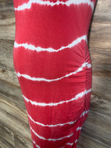 Side view of Isabel maternity bodycon mini dress in red tie-dye, showing ruched side seam and fitted silhouette on wood floor