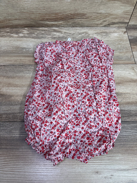 Janie & Jack ditsy floral ruffle romper in pink for babies size 6-12m on a wood background