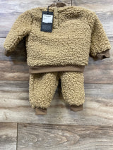 Tan sherpa fleece toddler outfit with sweater and pants on wood background