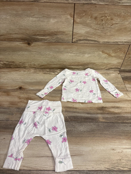 Just One You white 2-piece floral shirt and pants set for infants on a wood background