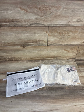White lace nursing bralette in clear packaging next to Davin & Adley Mimi and Pal storage bag on wood floor
