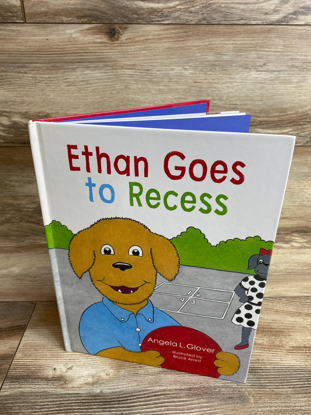 Children's book cover 'Ethan Goes to Recess' featuring a cartoon dog holding a red ball on a playground background