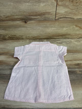 Back view of Monica + Andy pink striped seersucker button-up shirt in size 5T laid flat on a wood surface
