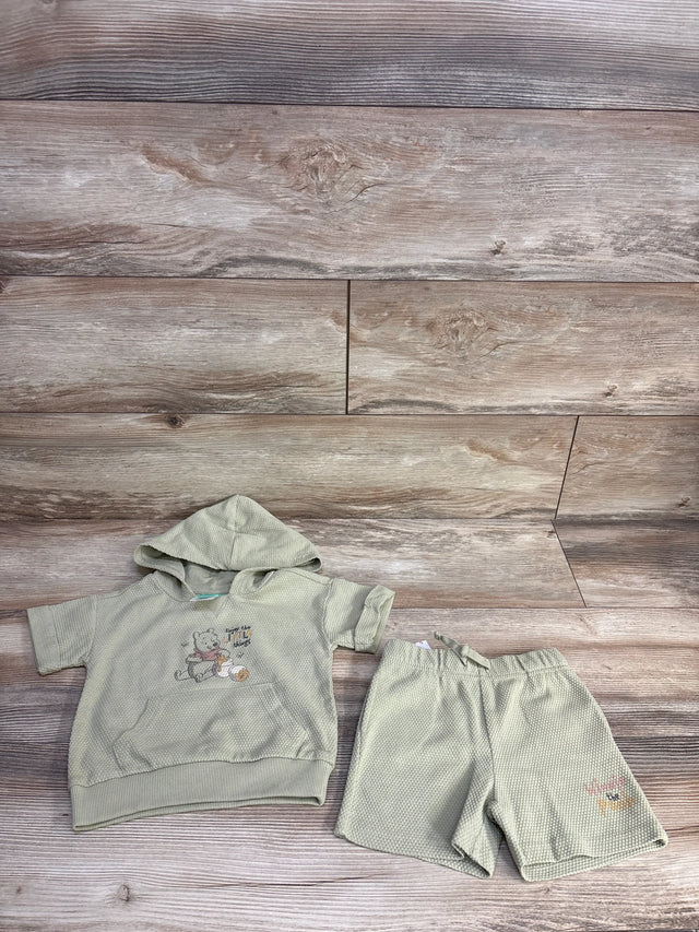 Front view of 2pc Disney Winnie the Pooh hooded top and shorts in sage, waffle knit with Pooh print on wood background