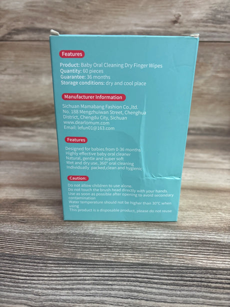 Back of Dearlomum baby oral cleaning dry finger wipes box showing 60 pieces and 0-36 month use on wood grain