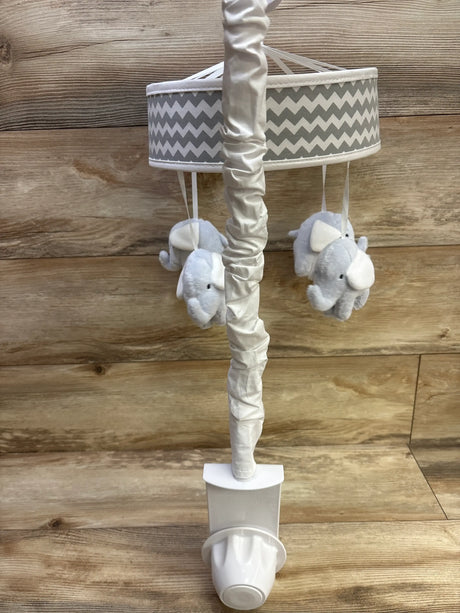 Front view of Trend Lab dove gray chevron musical crib mobile showcasing plush elephant toys with wood background