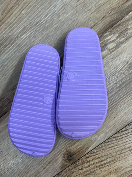 Bottom view of Cat and Jack purple toddler water shoes showcasing ribbed soles and size 10 marking on wood floor