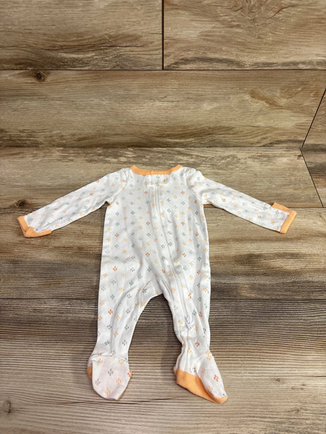 Top view of Cloud Island white newborn sleeper showcasing long sleeves, footed legs, and patterned fabric on a wood surface