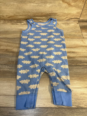 Blue baby romper with white cloud pattern on wooden floor
