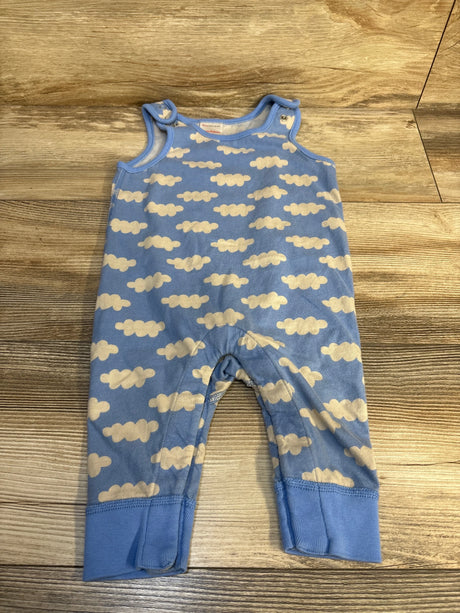 Blue baby romper with white cloud pattern on wooden floor