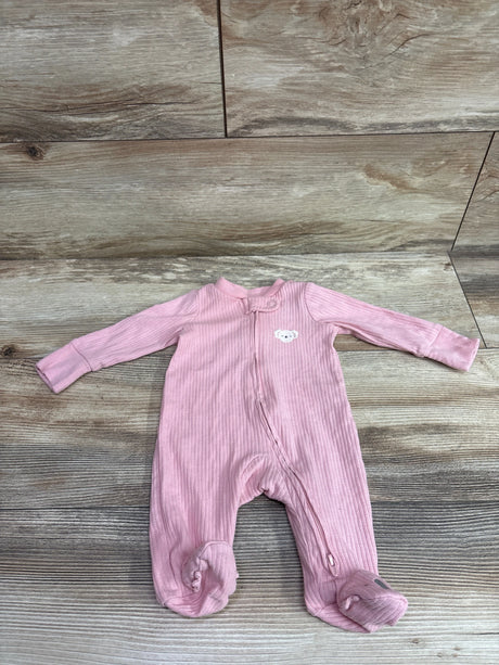 Front view of Carter’s pink ribbed newborn sleeper showcasing long sleeves, footed legs, and front zipper on a wood-patterned surface