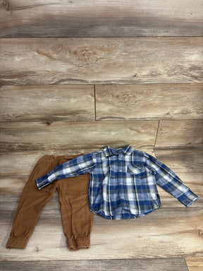Boy's brown jogger pants with blue plaid long-sleeve shirt on wood background