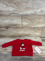 Front view of red baby sweatshirt with Mickey Mouse graphic and "Disneyland" text, ribbed cuffs and hem, size 3-6M tag on wood floor