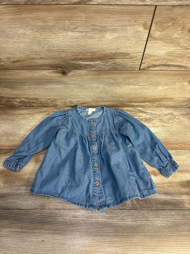 Baby denim long sleeve top with front buttons, laid on wood floor