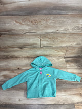 Toddler turquoise zip-up hoodie with hood and cute flower and bird embroidery, laid flat on wood floor