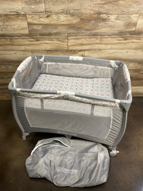 Front view of Cribette crib showcasing slatted sides and compact design on white background