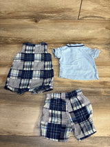Baby boy plaid romper, matching shorts, and blue polo shirt on wooden floor