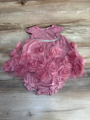 Pink baby dress with glittery top and 3D floral tulle skirt on wooden background