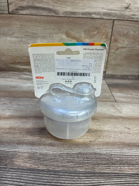 Front view of Nuby milk powder dispenser showcasing three clear stackable compartments and attached scoop on wood surface