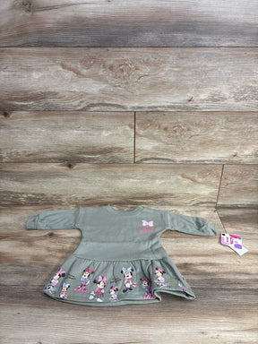Gray long sleeve toddler dress with Minnie Mouse print, laid flat on wood background