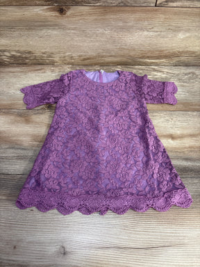 Flat lay of purple baby lace dress (12-18m) showing 3/4 sleeves, floral lace overlay, scalloped hem, and back zipper on wood background