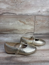 Side view of Jumping Beans Susie T-strap ballet flats in metallic gold size 8C showing T-strap and rounded toe on wood floor